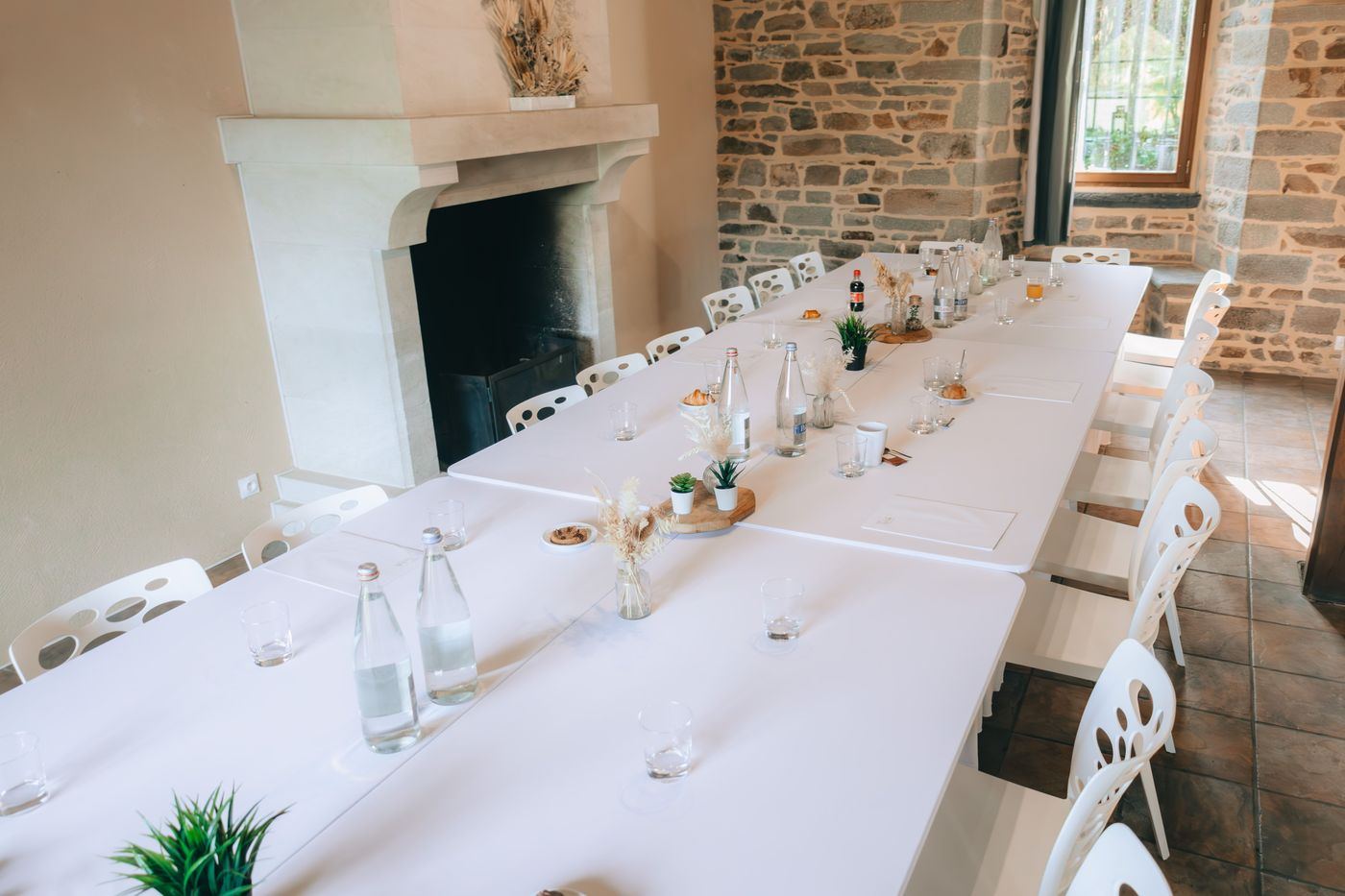 Long dining table in a stone room
