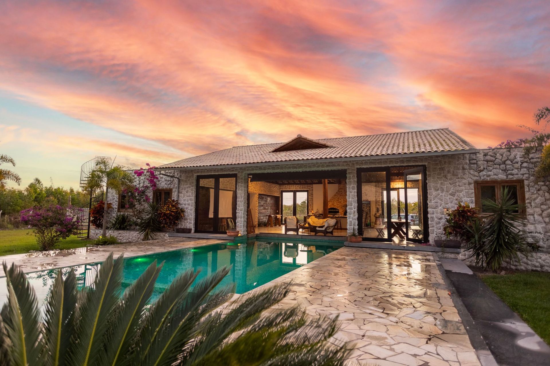 Stone villa with pool at dusk in Crete